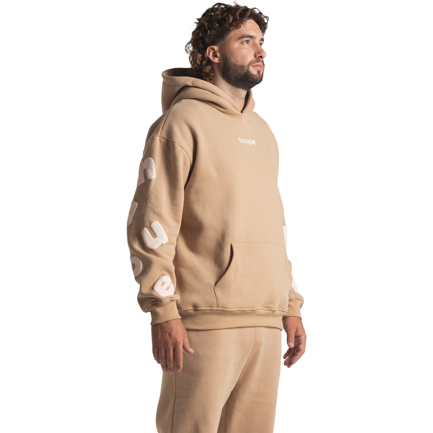 man wearing tan huupe sweats